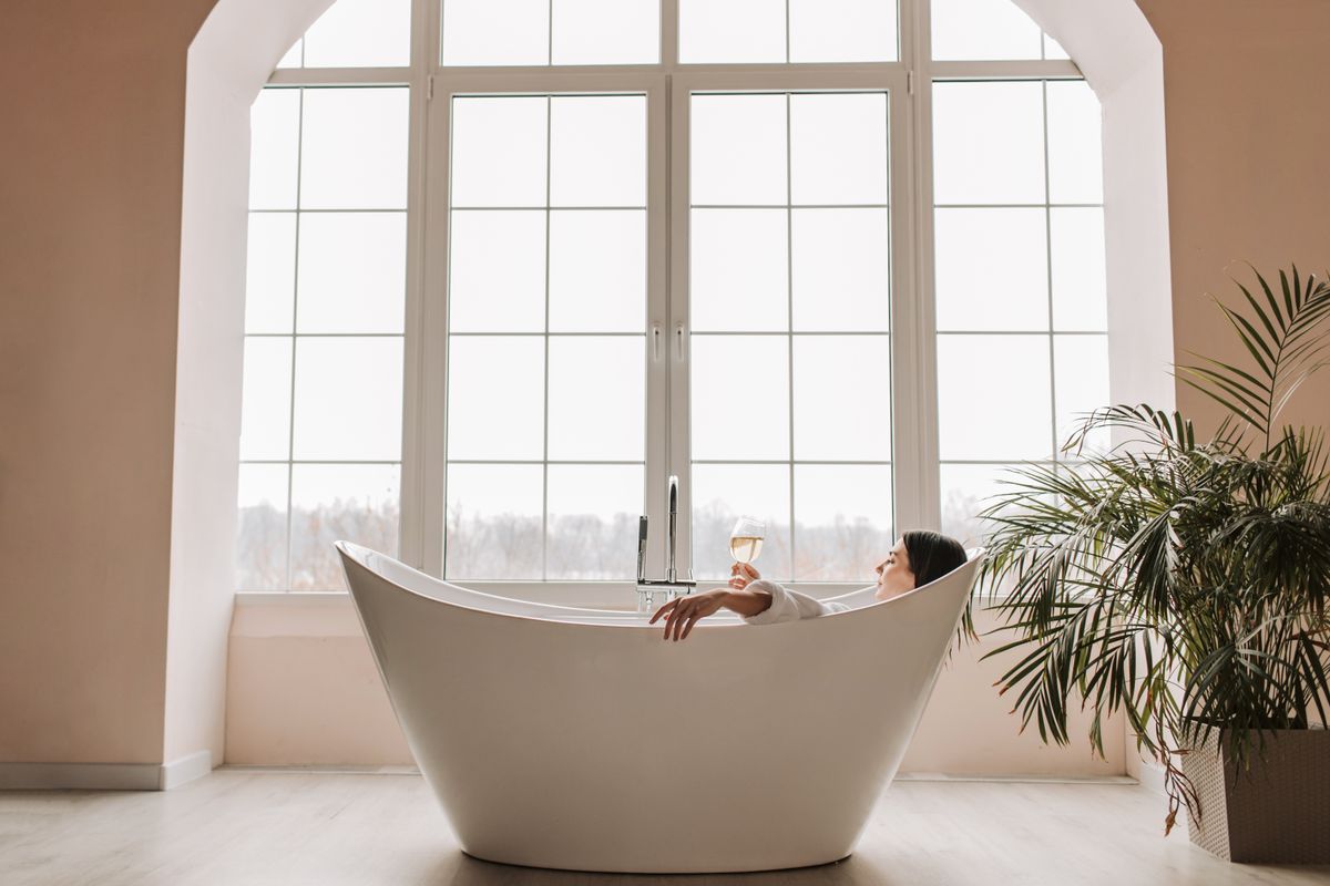 Bath salts beside a filled bathtub