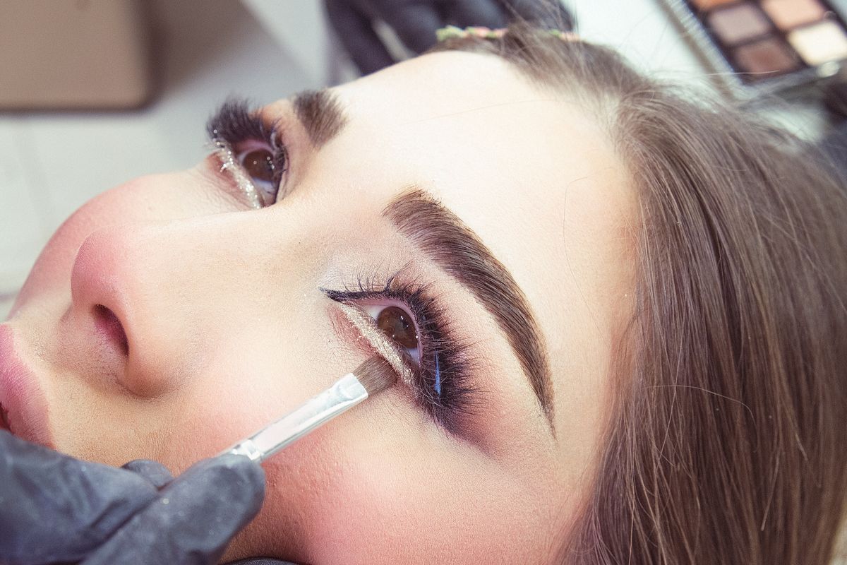 Concealer placed in a triangle beneath one eye before blending