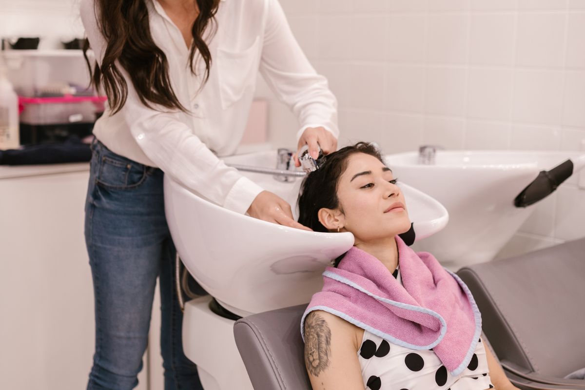 Hair being washed at a salon basin