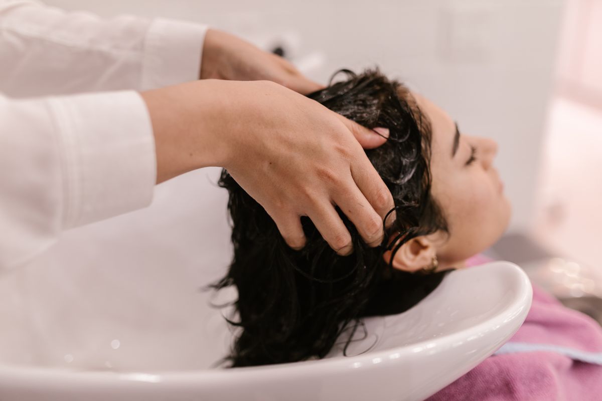 Hair being washed at a salon basin