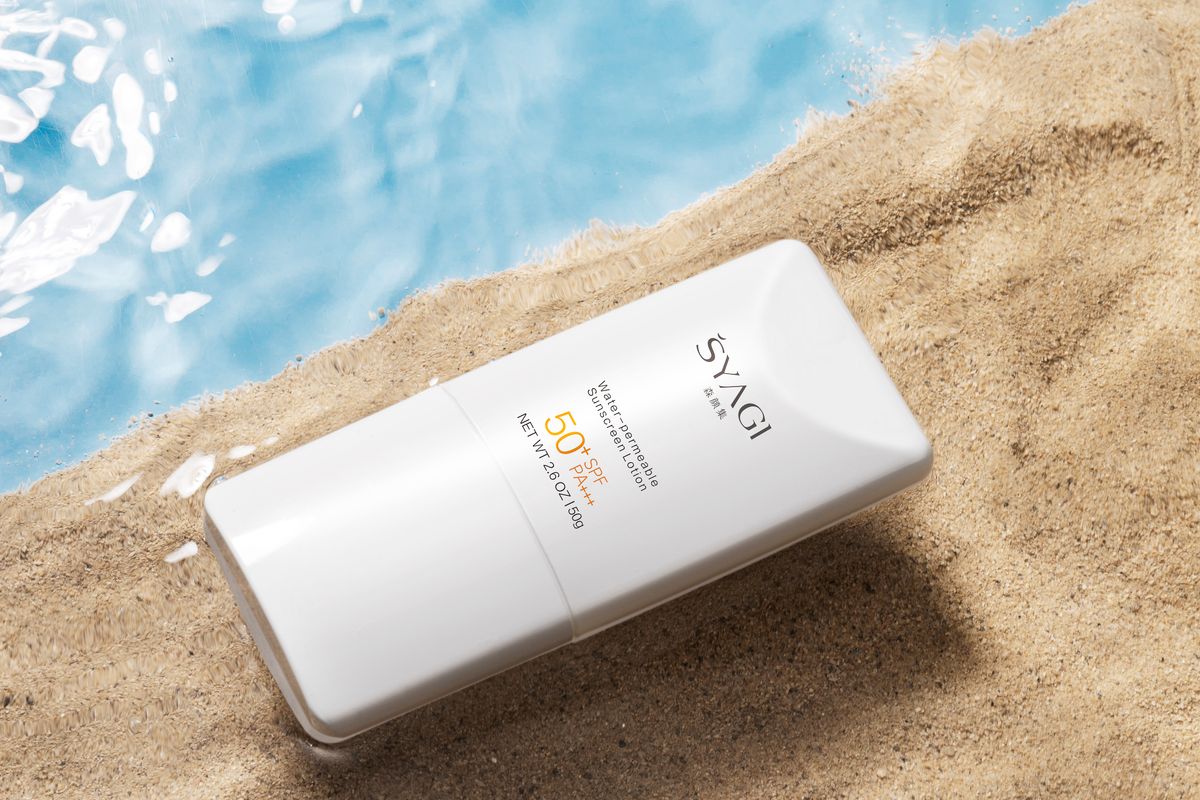 Swatches of tinted and untinted mineral sunscreen on a dark surface