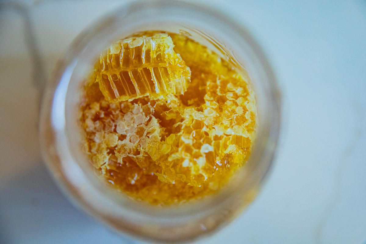 Open jar of face cream with rich texture